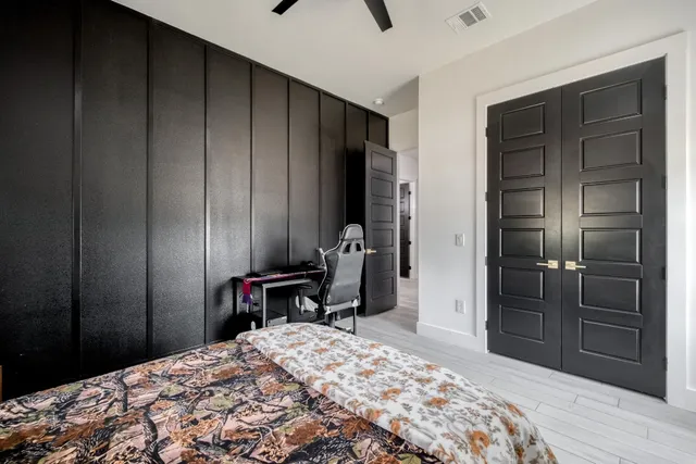 a bedroom with a bed and a dresser in it