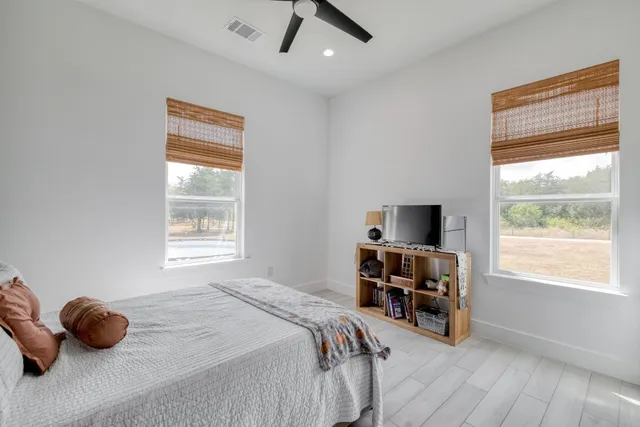 a bedroom with furniture and a window