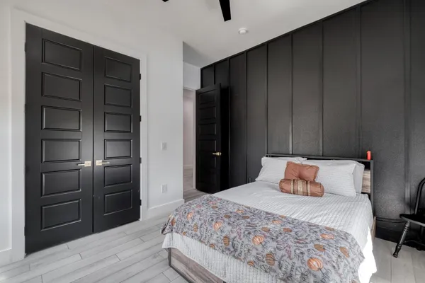 a bedroom with a bed and wooden floor