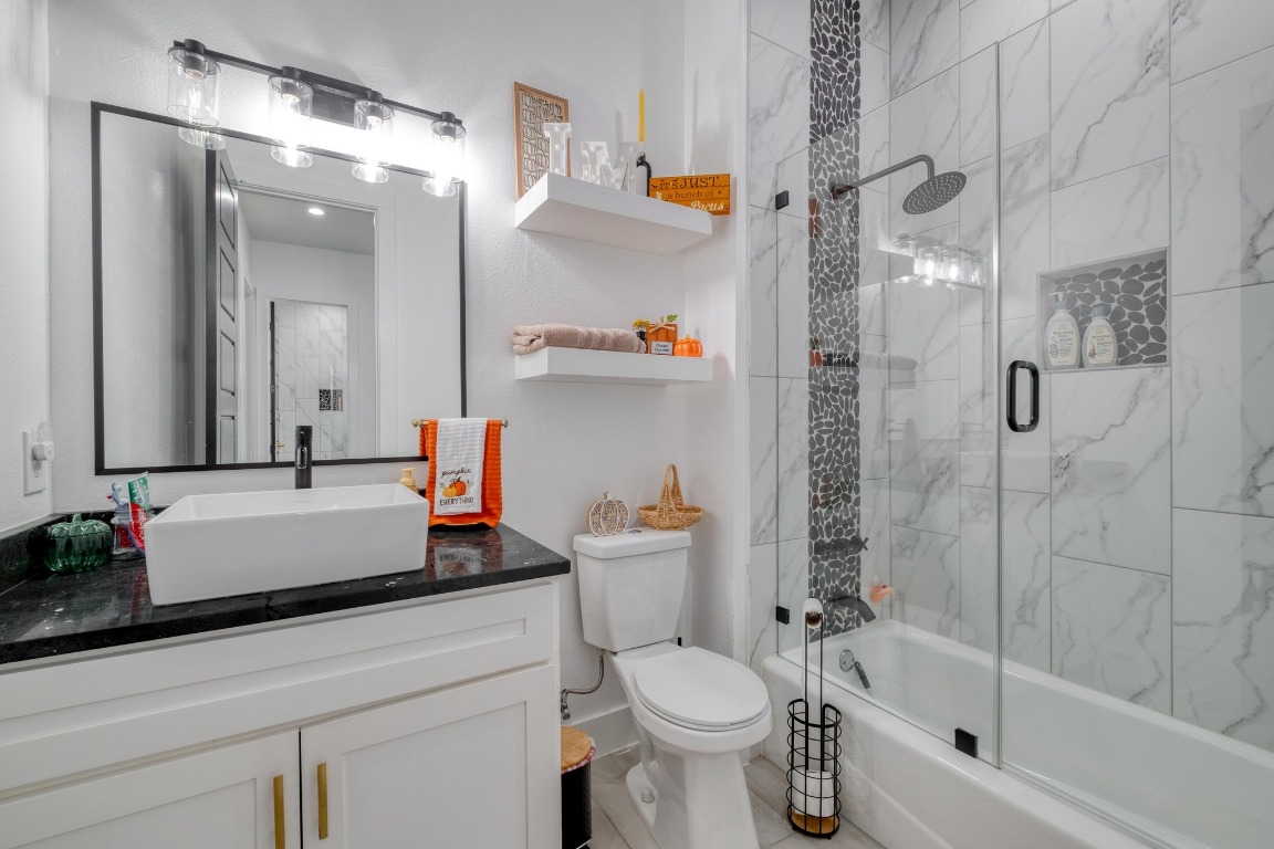 1901 Highway 21, Unit B Paige, TX 78659 - Photo 17 of 40 a bathroom with a bathtub shower sink vanity and toilet