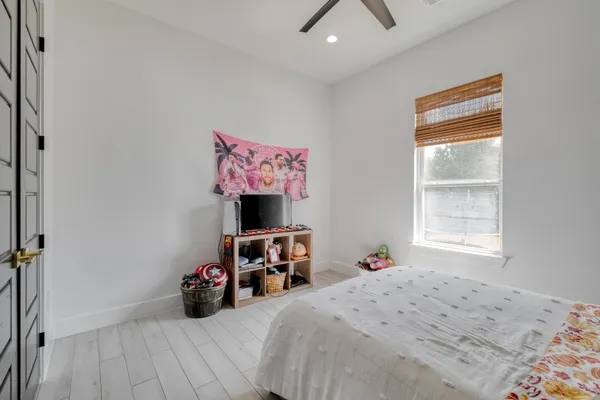 a bedroom with a bed a table and a window