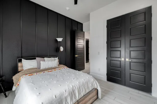 a bedroom with a bed and a closet