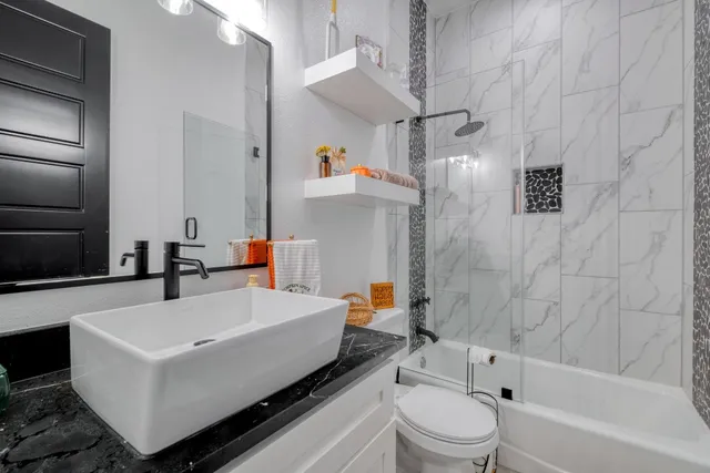 a bathroom with a sink a toilet and a bathtub