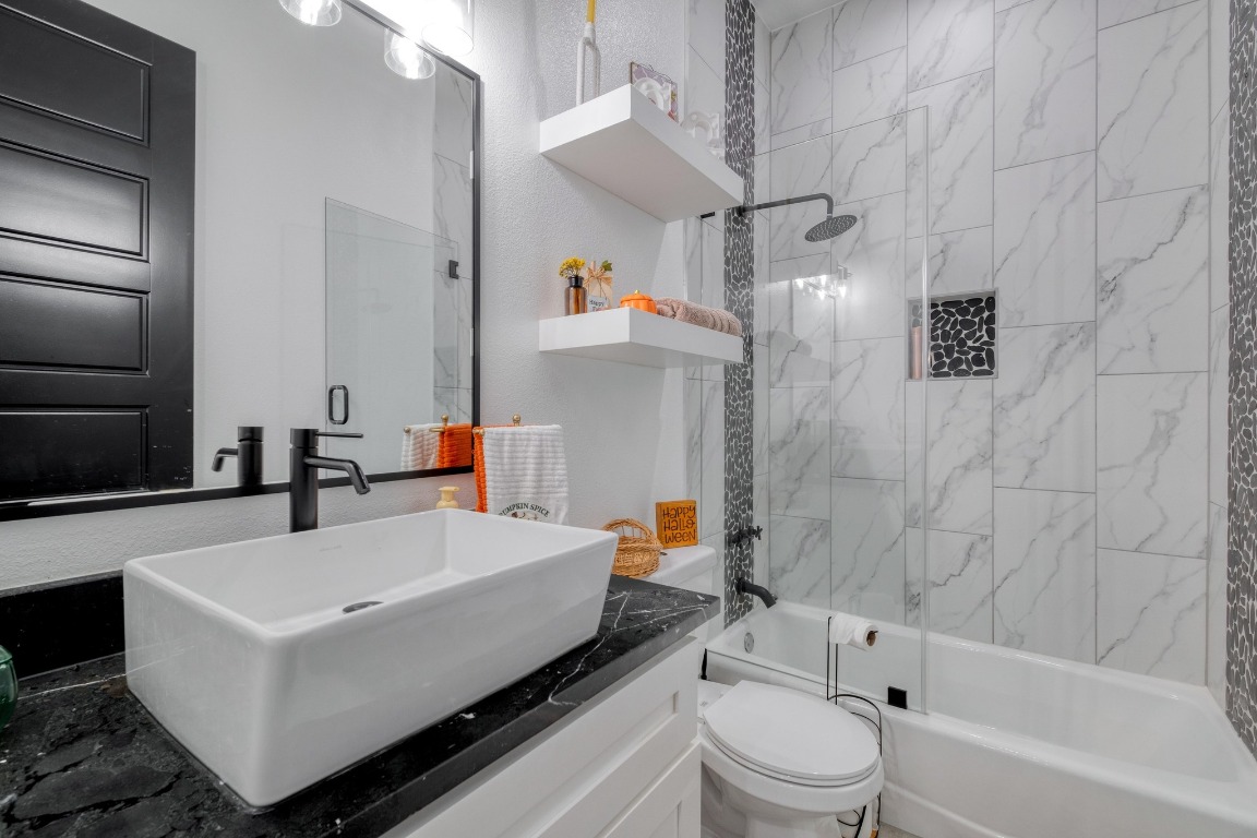 1901 Highway 21, Unit B Paige, TX 78659 - Photo 20 of 40 a bathroom with a sink a toilet and a bathtub