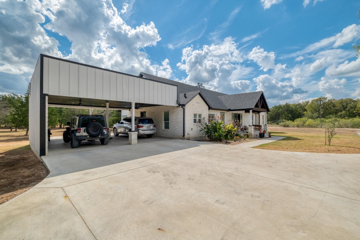 1901 Highway 21, Unit B Paige, TX 78659 - Photo 2 of 40 a view of a patio with couches and table and chairs under an umbrella