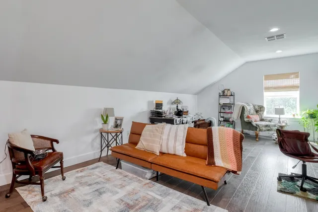 a living room with furniture a rug and a window