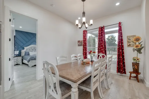 a view of a dining room with furniture chandelier and a chandelier