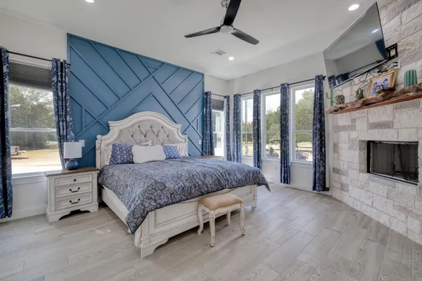 a spacious bedroom with a bed and a fireplace