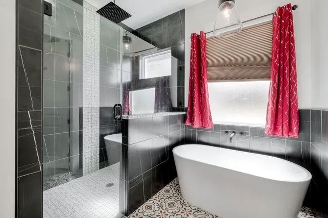 a bathroom with a bathtub and a shower