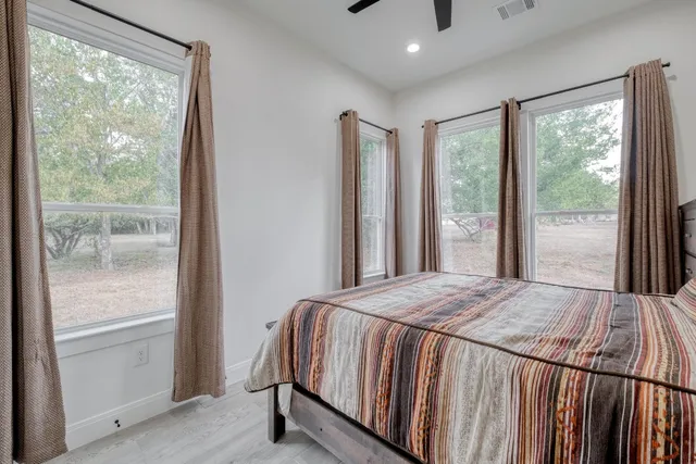 a bedroom with a bed and a large window