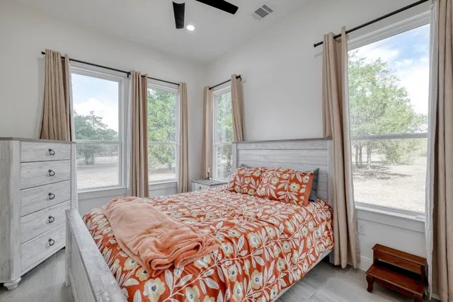 a bedroom with a large bed and a window