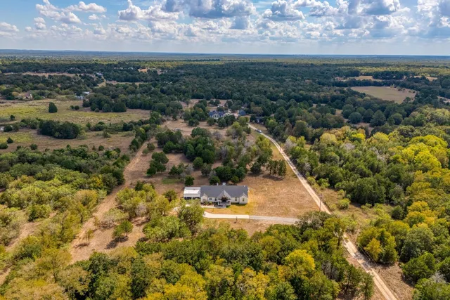 an aerial view of residential houses with outdoor space
