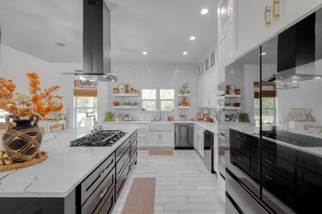 a kitchen with stainless steel appliances a sink stove and cabinets