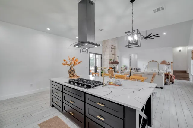 a kitchen with a counter space a stove and cabinets