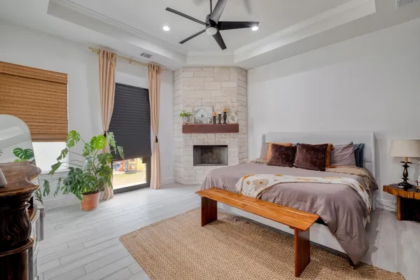 a bedroom with furniture and a fireplace