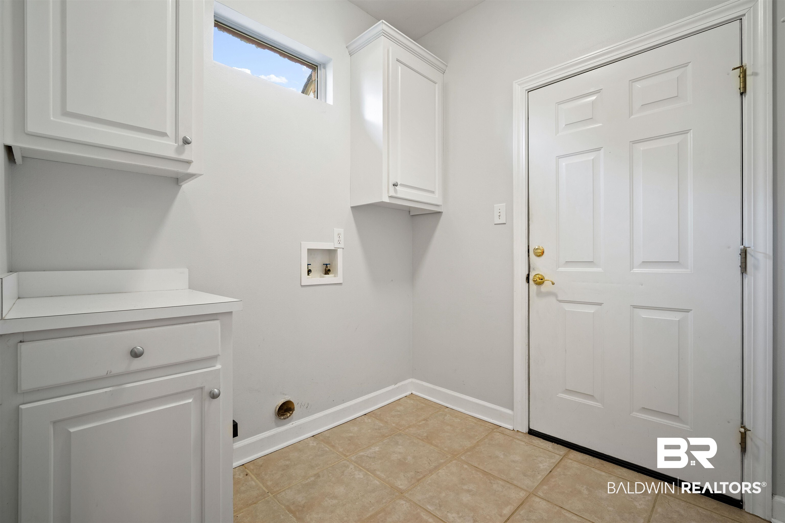 204 General Canby Loop Daphne, AL 36527 - Photo 16 of 36 Laundry area featuring hookup for a washing machine, light tile patterned floors, and cabinets