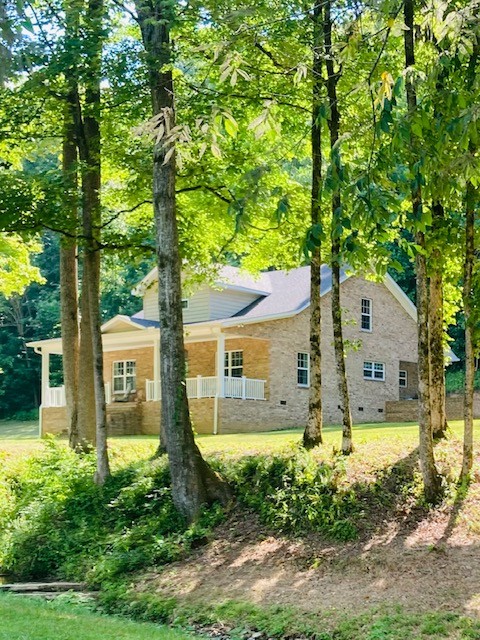 61 Spring Valley Road Taft, TN 38488 - Photo 1 of 29 a front view of a house with garden