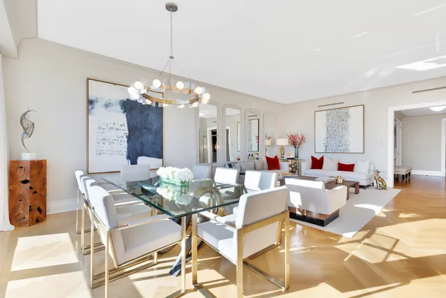 a living room with furniture and a chandelier