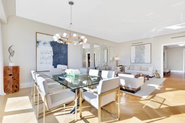 a view of a dining room with furniture and chandelier