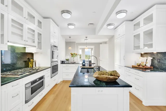 a kitchen with sink stove and cabinets