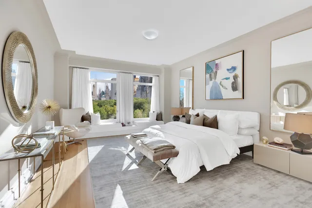 a spacious bedroom with a bed a dresser next to a large window