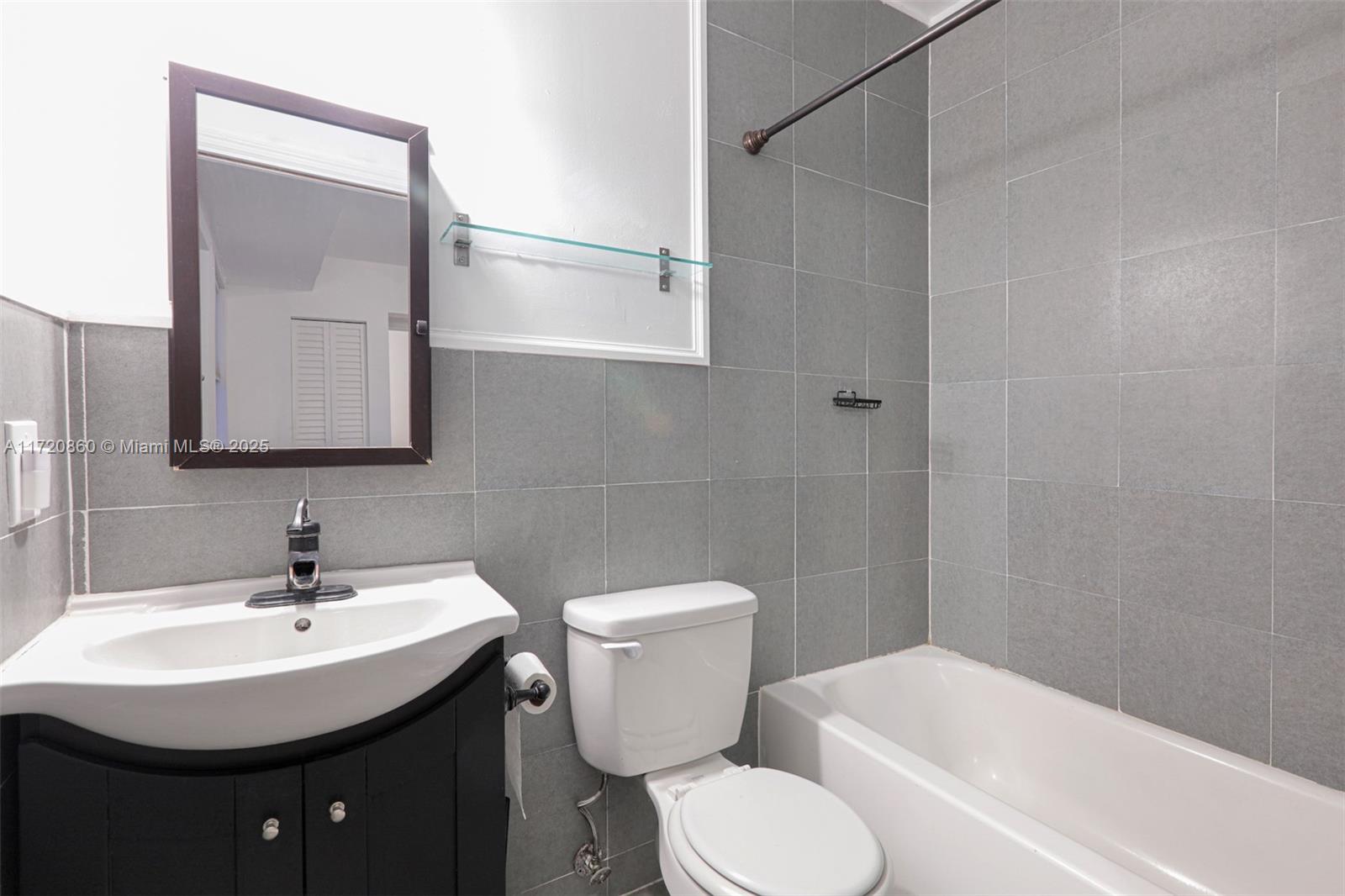 931 79th Terrace, Unit B Miami Beach, FL 33141 - Photo 5 of 9 a bathroom with a sink toilet and shower