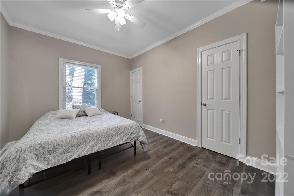 1012 Queens Road, Unit C Charlotte, NC 28207 - Photo 13 of 30 a bedroom with a large bed and a chandelier