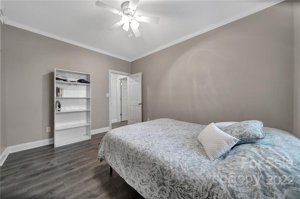 1012 Queens Road, Unit C Charlotte, NC 28207 - Photo 14 of 30 a bedroom with a bed and a chandelier