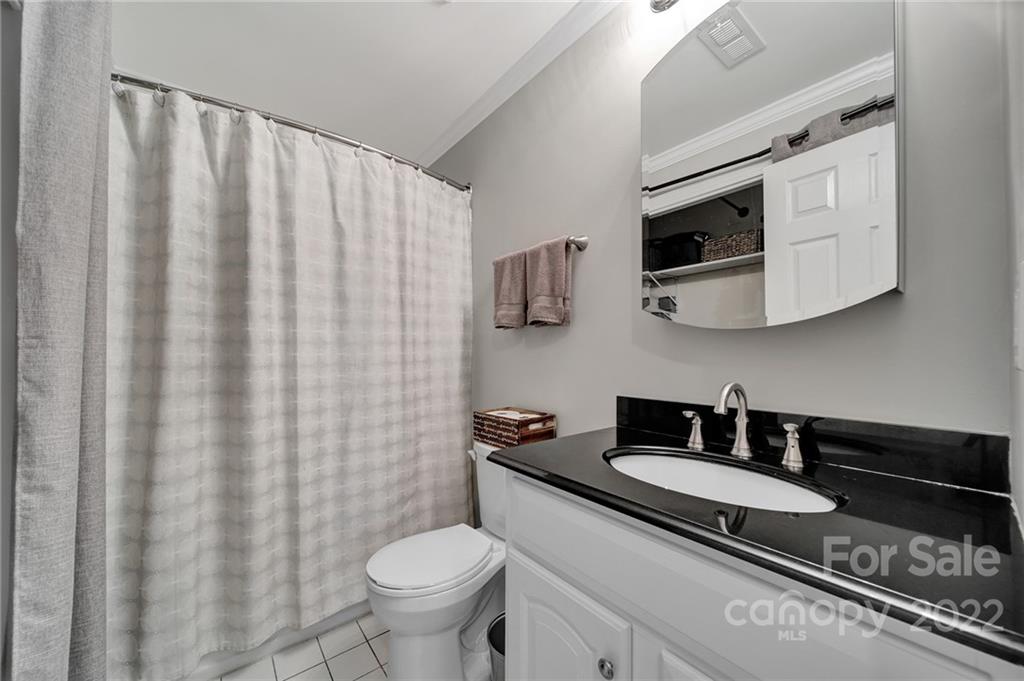 1012 Queens Road, Unit C Charlotte, NC 28207 - Photo 15 of 30 a bathroom with a granite countertop sink and a mirror