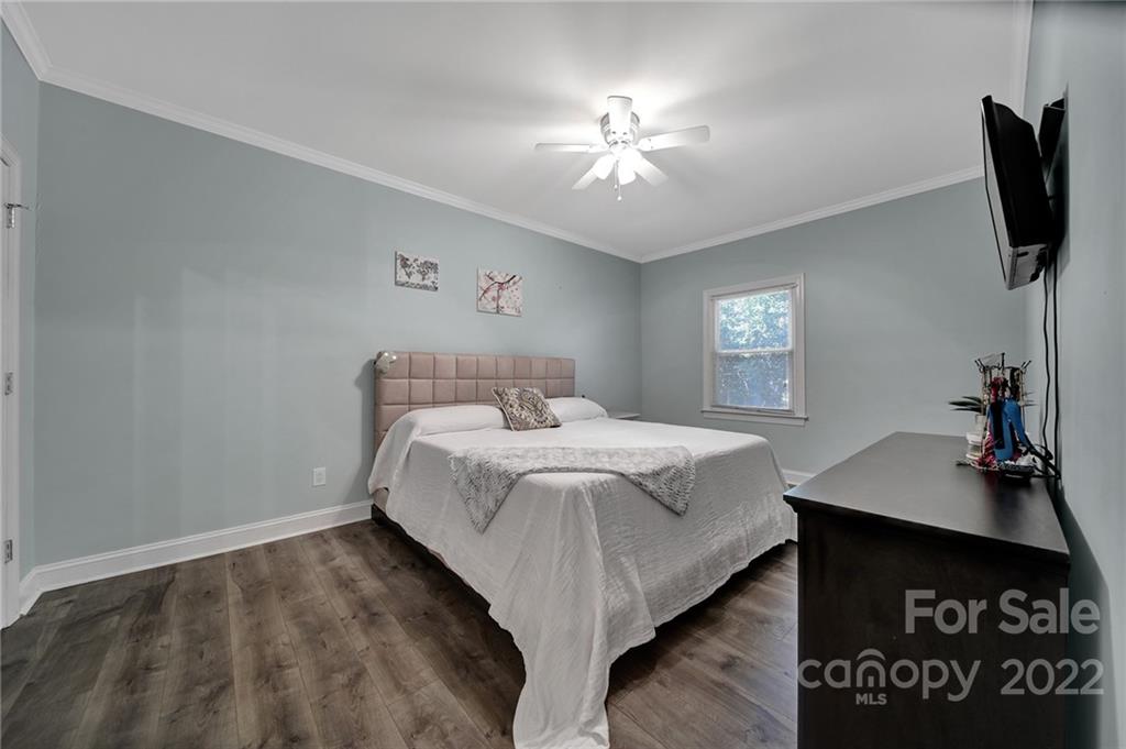 1012 Queens Road, Unit C Charlotte, NC 28207 - Photo 16 of 30 a bedroom with a bed and a flat screen tv