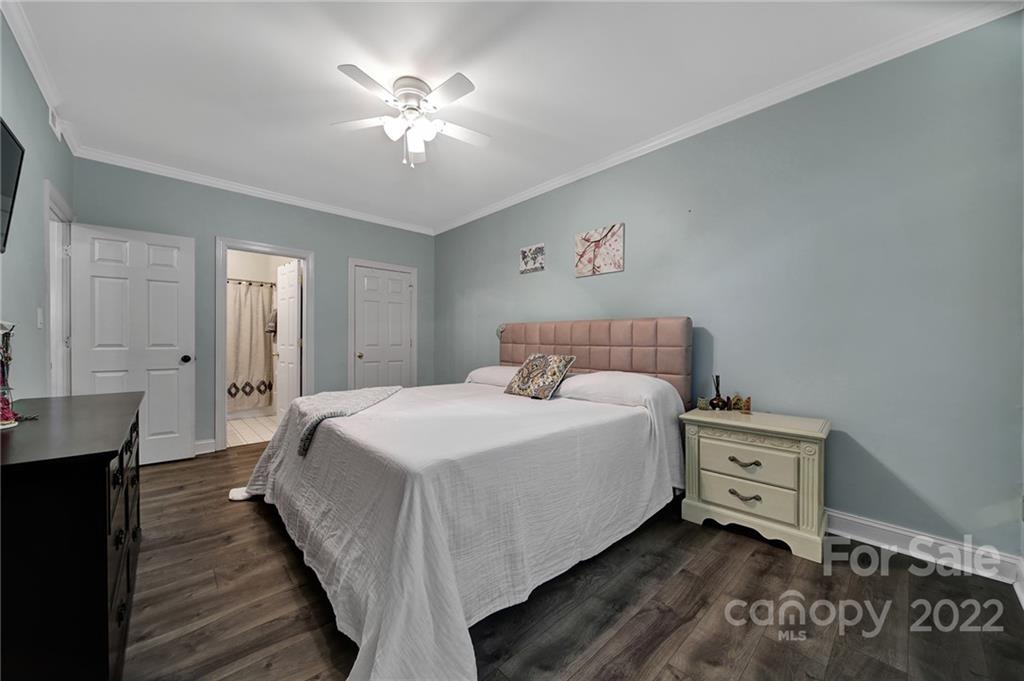 1012 Queens Road, Unit C Charlotte, NC 28207 - Photo 17 of 30 a bedroom with a bed and a chandelier