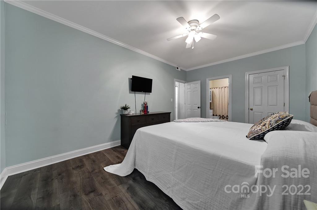 1012 Queens Road, Unit C Charlotte, NC 28207 - Photo 18 of 30 a bedroom with a bed and a chandelier