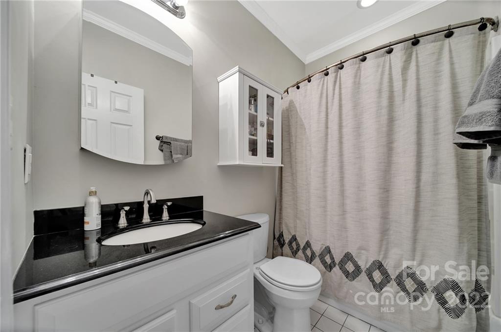 1012 Queens Road, Unit C Charlotte, NC 28207 - Photo 19 of 30 a bathroom with a granite countertop sink and a mirror
