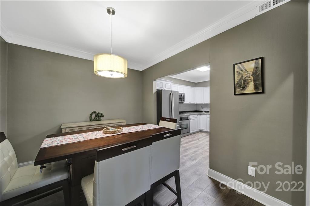 1012 Queens Road, Unit C Charlotte, NC 28207 - Photo 7 of 30 a room with a table chairs and wooden floor
