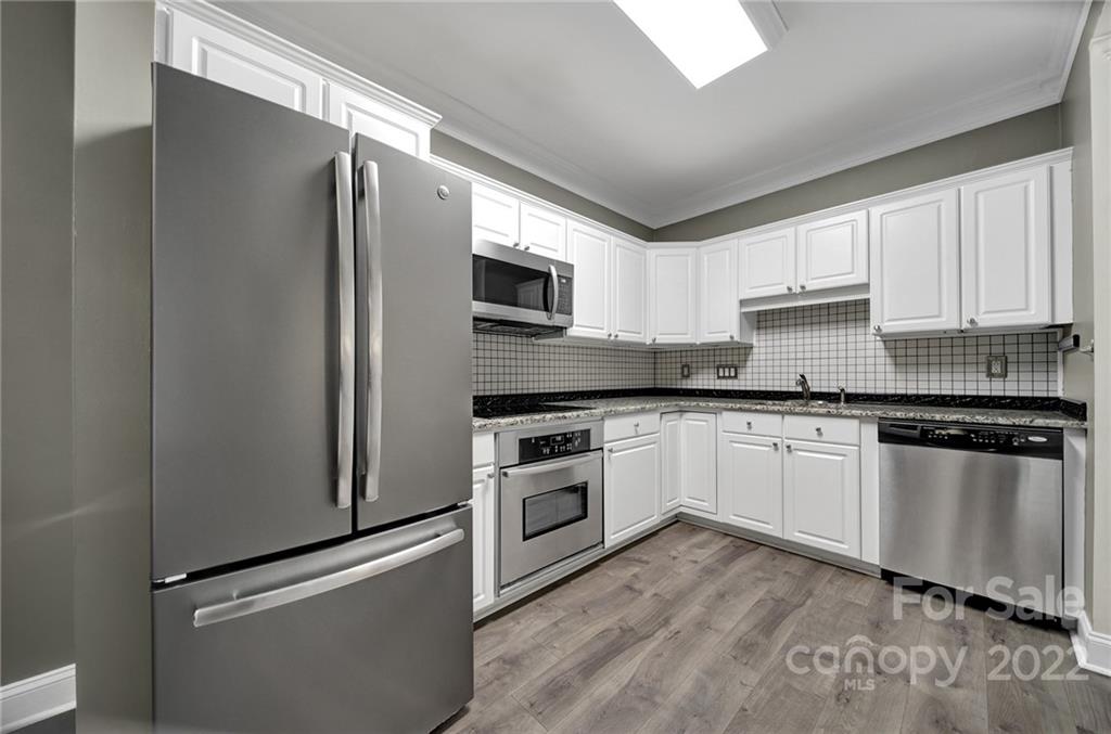 1012 Queens Road, Unit C Charlotte, NC 28207 - Photo 10 of 30 a kitchen with granite countertop a refrigerator stove and microwave