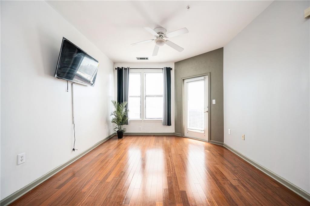 898 Oak Street Southwest, Unit 1418 Atlanta, GA 30310 - Photo 8 of 22 a view of a livingroom with wooden floor and a ceiling fan