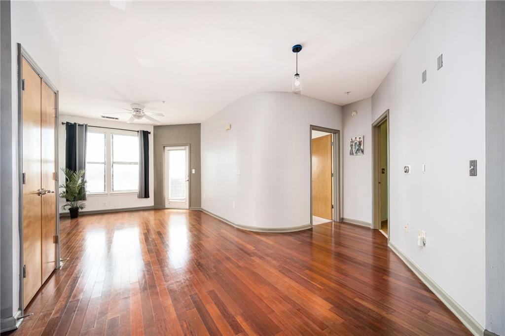 898 Oak Street Southwest, Unit 1418 Atlanta, GA 30310 - Photo 9 of 22 a view of an empty room with wooden floor and a window