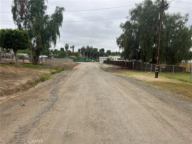 a view of a dirt road and a building