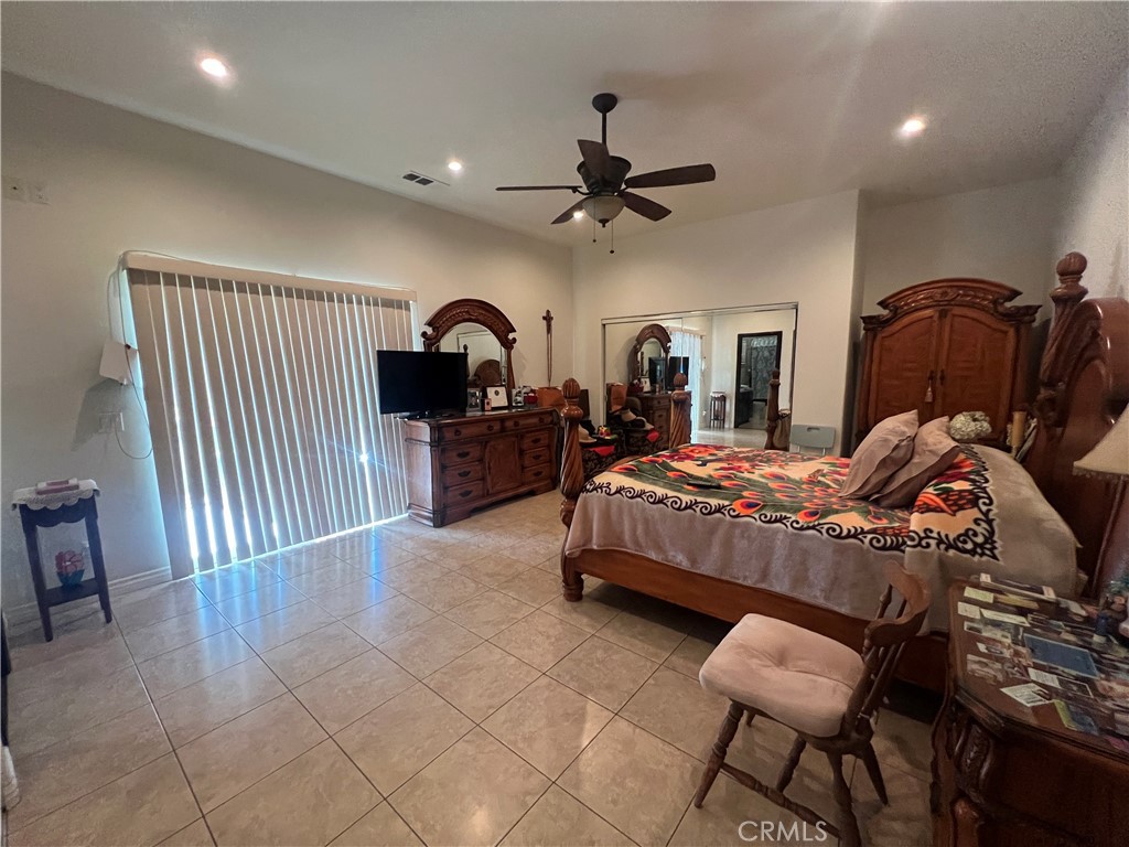 17305 Sage Avenue Riverside, CA 92504 - Photo 8 of 40 a bedroom with a bed and a chandelier