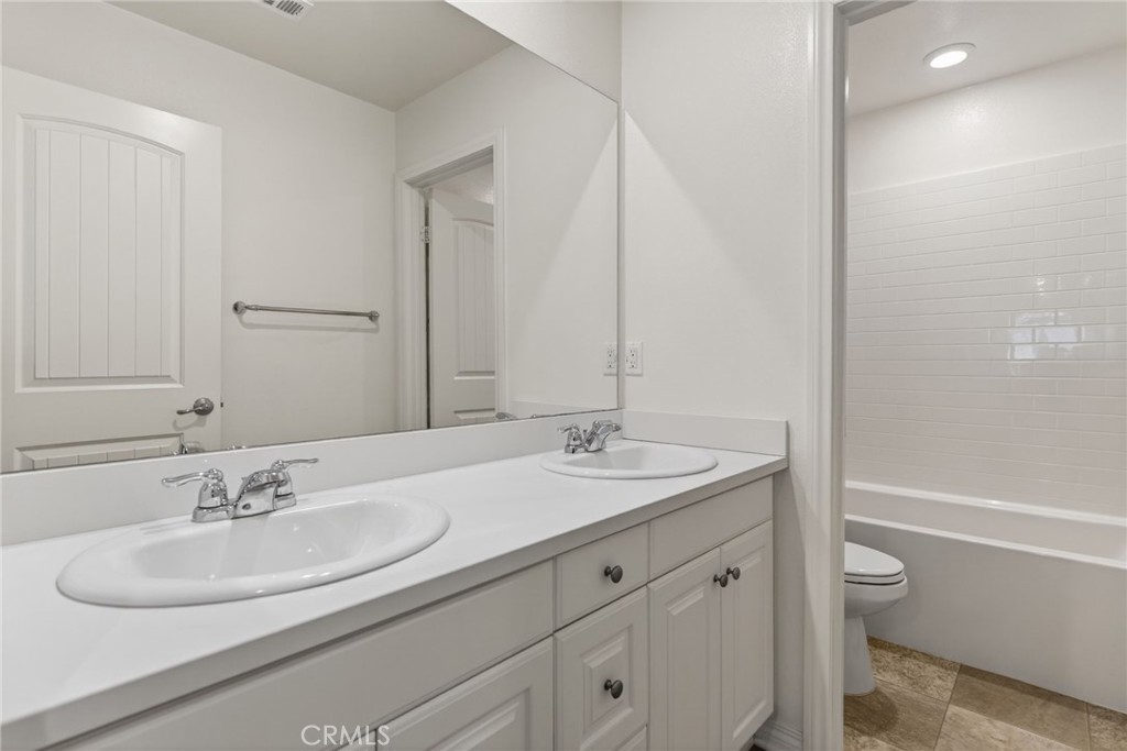 19435 Fortunello Avenue Riverside, CA 92508 - Photo 42 of 51 a bathroom with a sink and a mirror with toilet