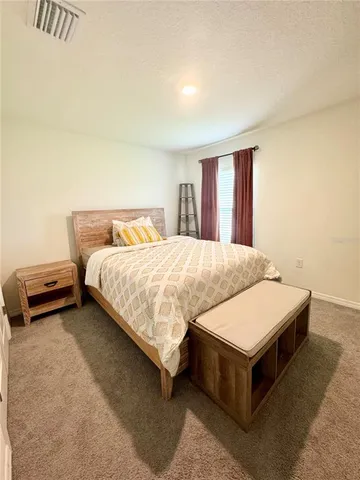 a bedroom with a bed and window