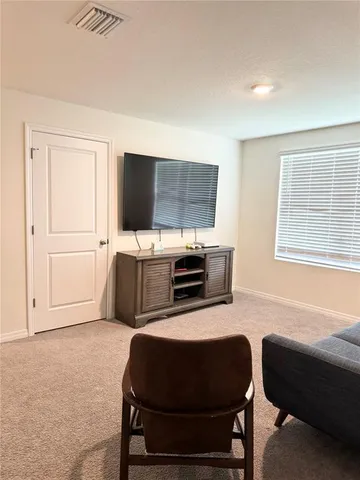a room with furniture and a flat screen tv