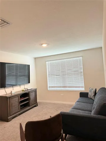 a living room with fireplace furniture and a flat screen tv