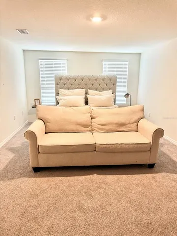 a spacious bedroom with a bed and a couch