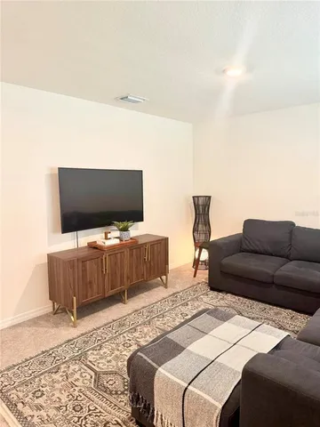 a living room with a couch and a flat screen tv