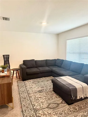 a living room with a couch and a stove