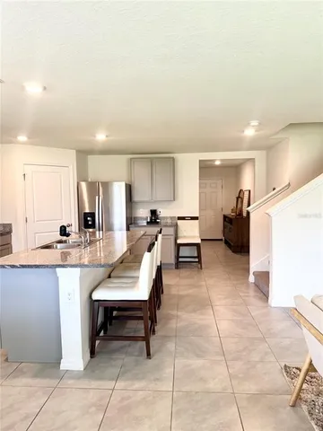 a living room with stainless steel appliances kitchen island granite countertop furniture and a kitchen view