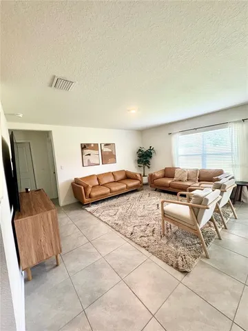 a living room with furniture and a window