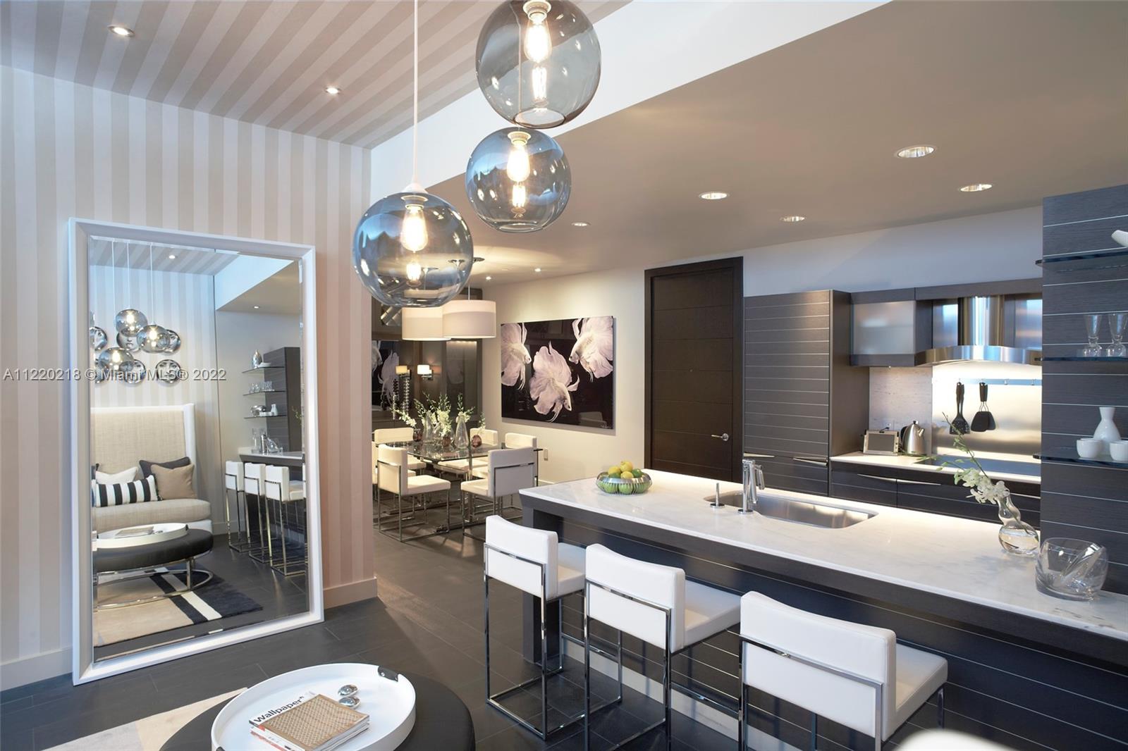 200 Biscayne Blvd Way, Unit 5211 Miami, FL 33131 - Photo 4 of 11 a kitchen with a dining table and chairs