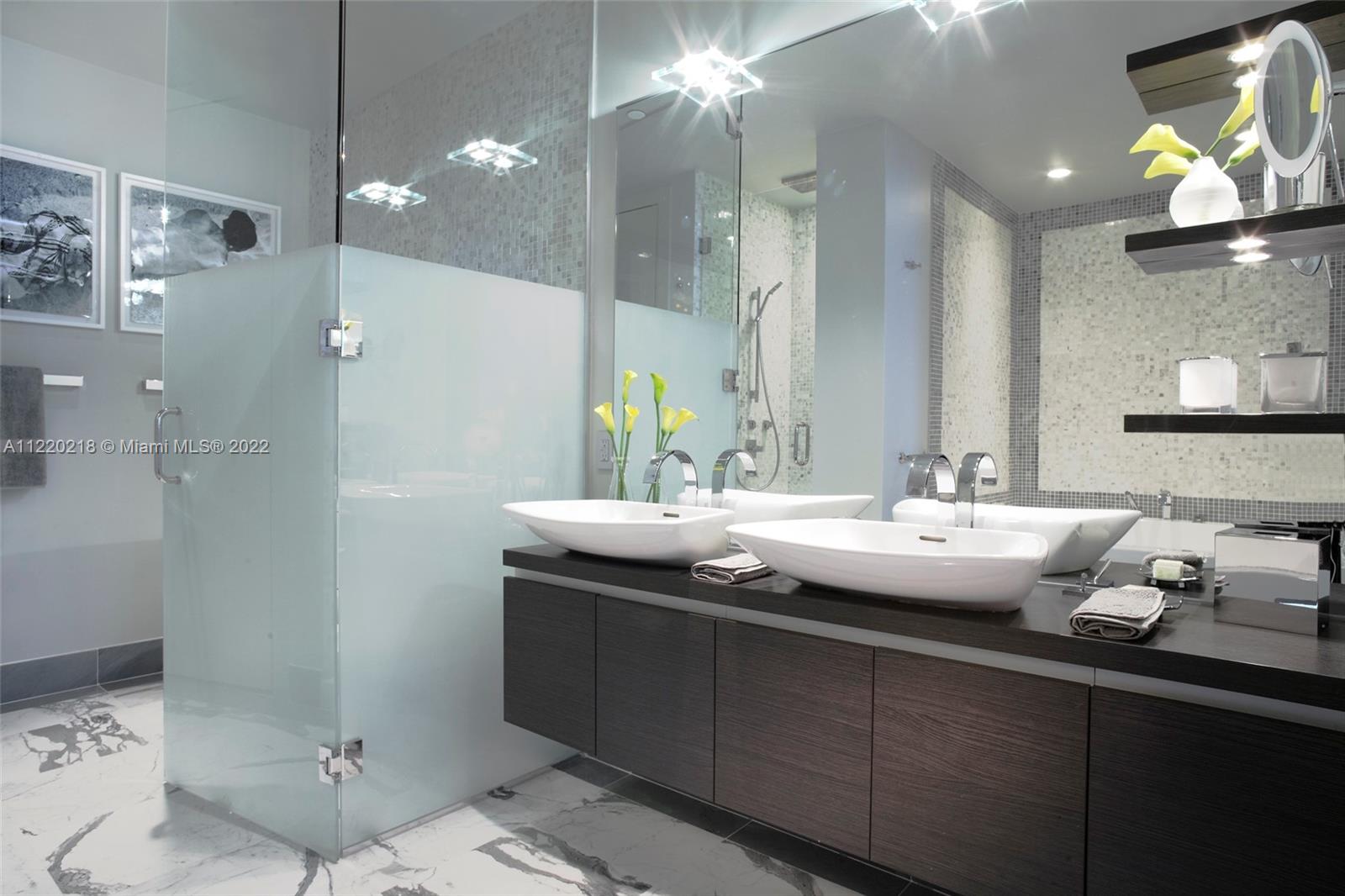 200 Biscayne Blvd Way, Unit 5211 Miami, FL 33131 - Photo 8 of 11 a bathroom with a sink and a mirror